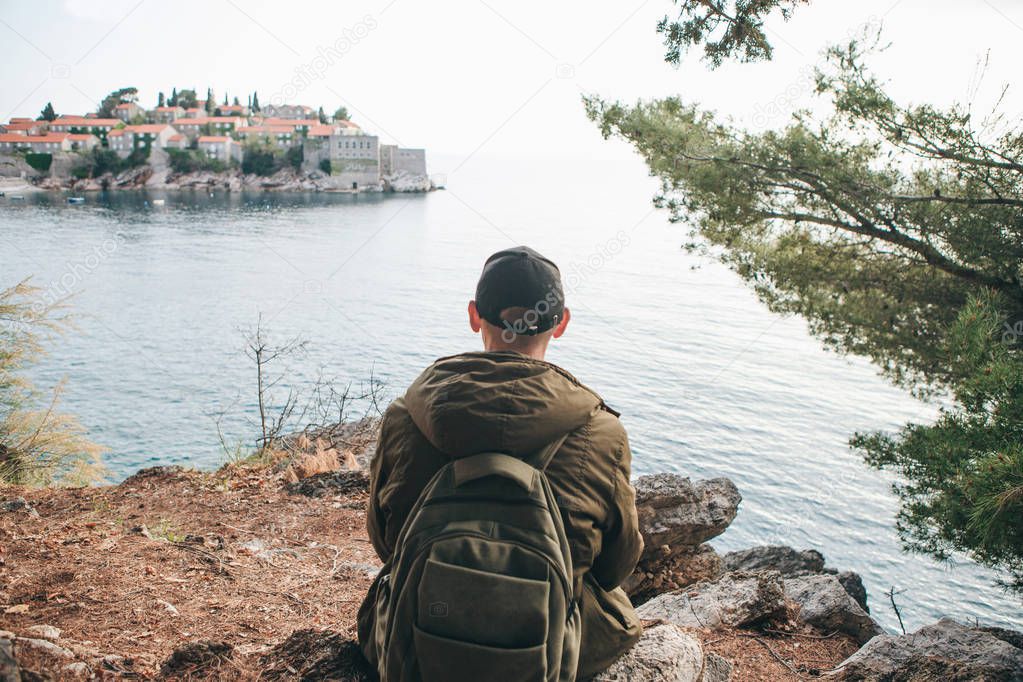 Tourist with a backpack near the sea