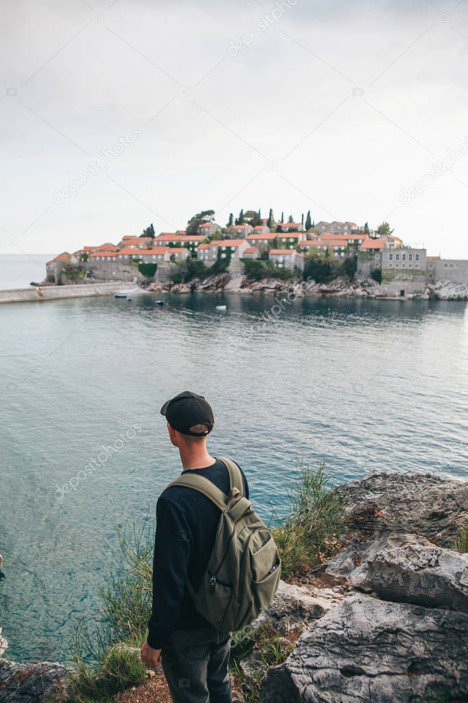 Tourist with a backpack near the sea
