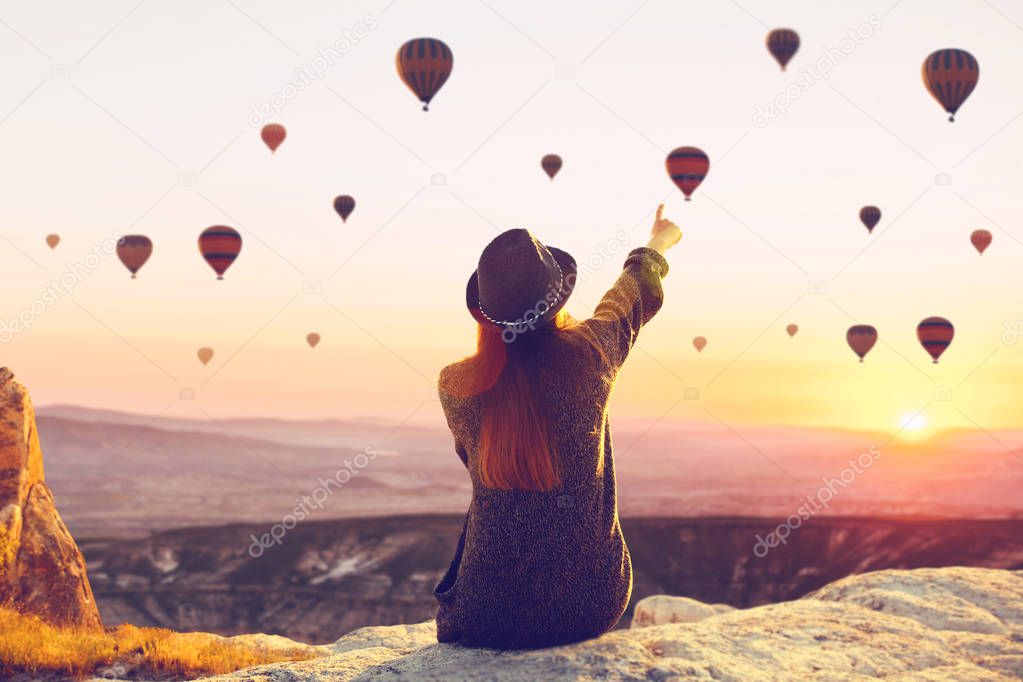 Woman admires flying balloons