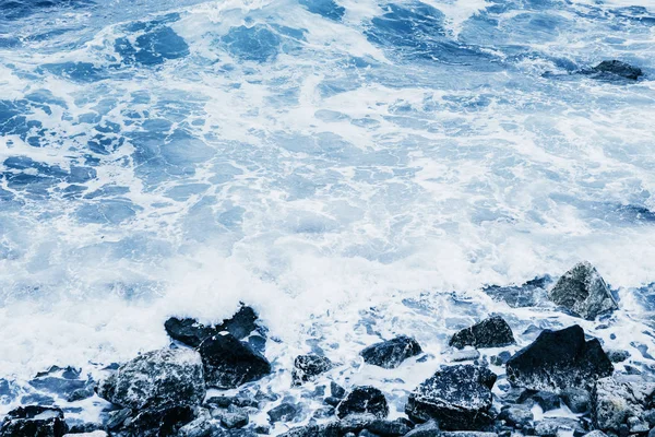 Rusteloze zee in de buurt van de stenen kust. — Stockfoto