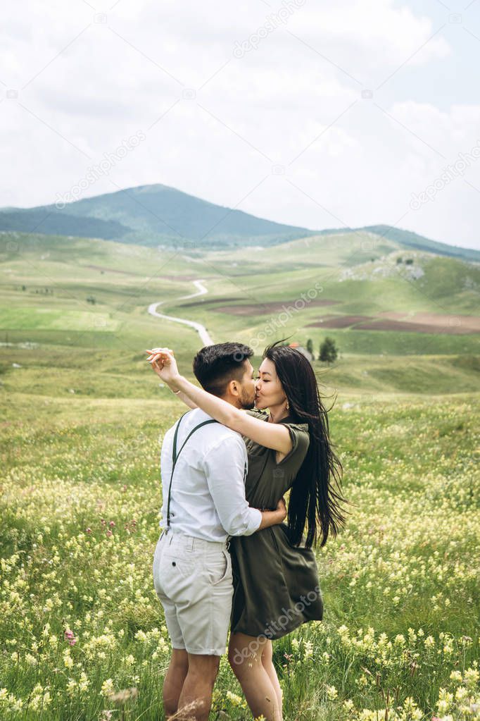 Woman hugs a man in the field