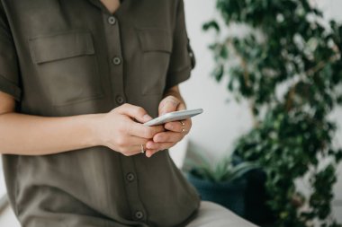 Yakın çekim - bir kız cep telefonu ya da cep telefonu kullanıyor.