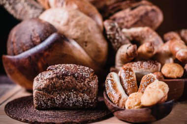 Tahta çeşitli ekmek dolu kase ve mal masaya pişmiş.  