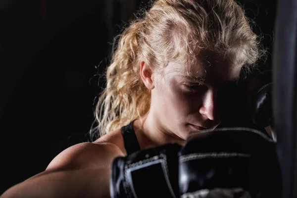 Young Sporty Female Hitting Boxing Bag Wearing Black Boxing Gloves — Stock Photo, Image