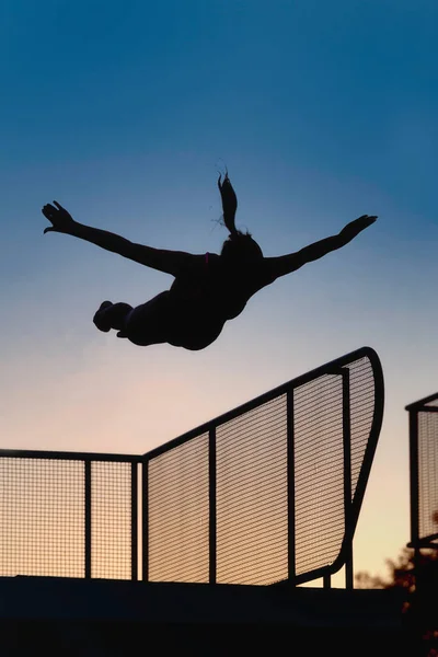 Kobiece Skakać Trampoliny Zmierzchu — Zdjęcie stockowe