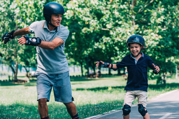 Roller skating race, grandfather and grandson having fun