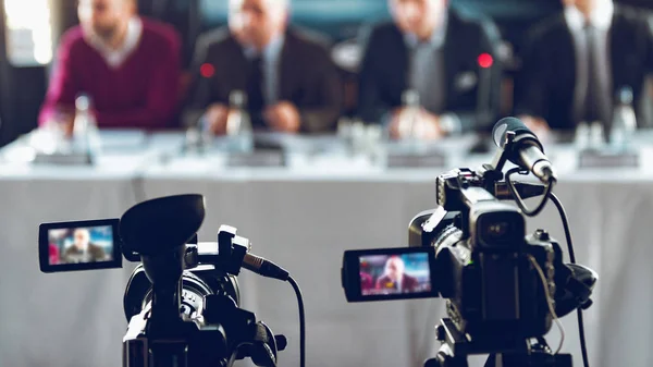 Two Cameras Recording Presentation Press Conference Blurred Speakers Wearing Suit — Stock Photo, Image
