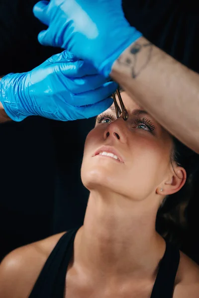 Schöne Junge Frau Bekommt Ihr Nasenstechpiercing Körperpiercer Trägt Blaue Handschuhe — Stockfoto