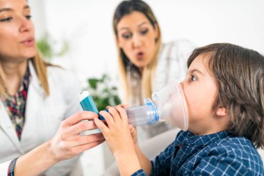 Pulmonology Doctor Helping Little Boy with Inhaler clipart