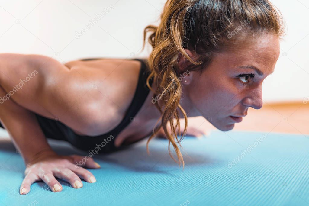 Doing Push-Ups. Woman Doing HIIT or High Intensity Interval Training Exercises