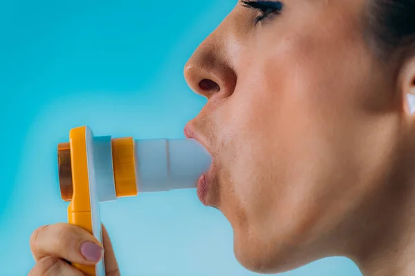 Woman Monitoring Respiratory Illness with Spirometer