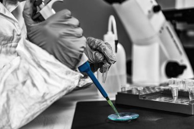 Adli tıp uzmanı laboratuvarda bilinmeyen şüpheli maddeyi inceliyor..