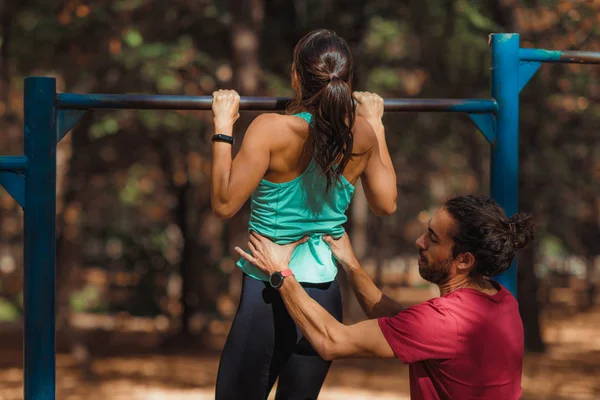 Mujer Haciendo Pull Ups Parque Con Entrenador Personal —  Fotos de Stock