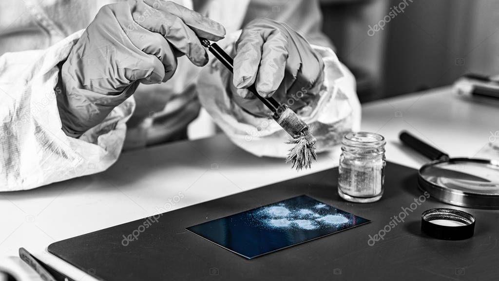 Forensic science investigator collecting fingerprints