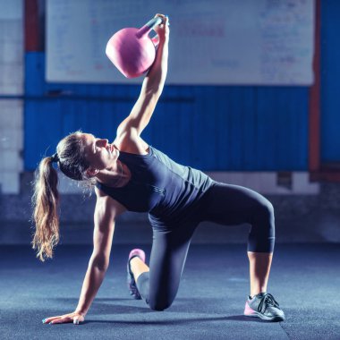 Kadın atlet kettlebell ile kapalı egzersiz