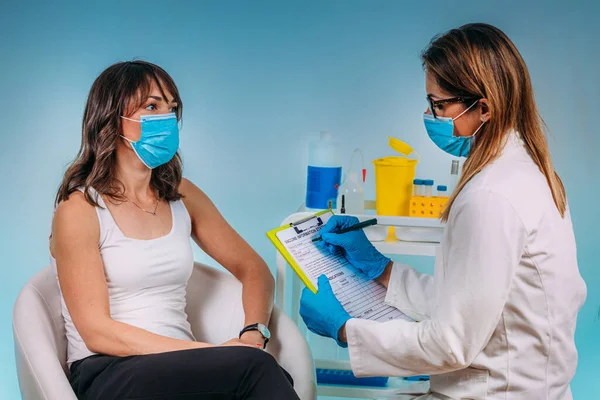 Corona Virus Vaccinatie Verpleegster Met Een Beschermend Masker Vult Formulier — Stockfoto