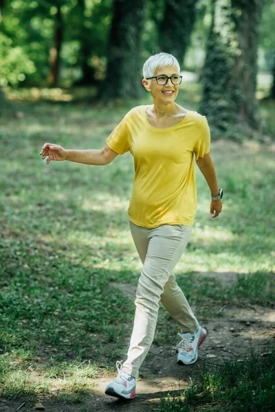 Senior woman enjoying walking exercise in nature