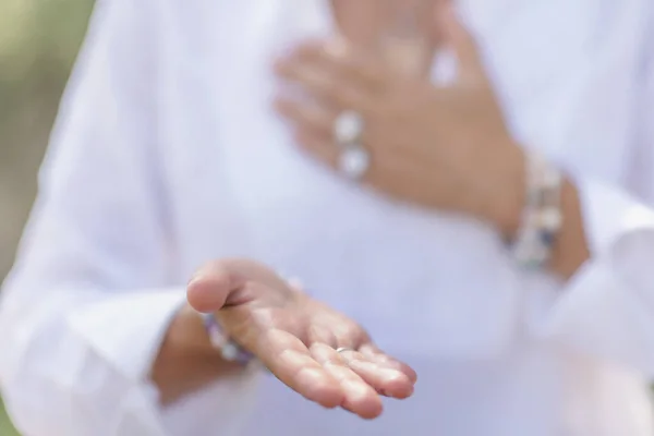 Female spiritual healer practicing mindfulness, sensing and increasing positive energy. Hand gesture