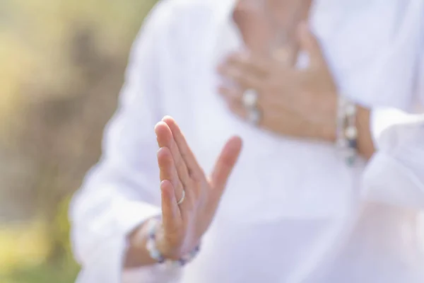 Female spiritual healer practicing mindfulness, sensing and increasing positive energy. Hand gesture