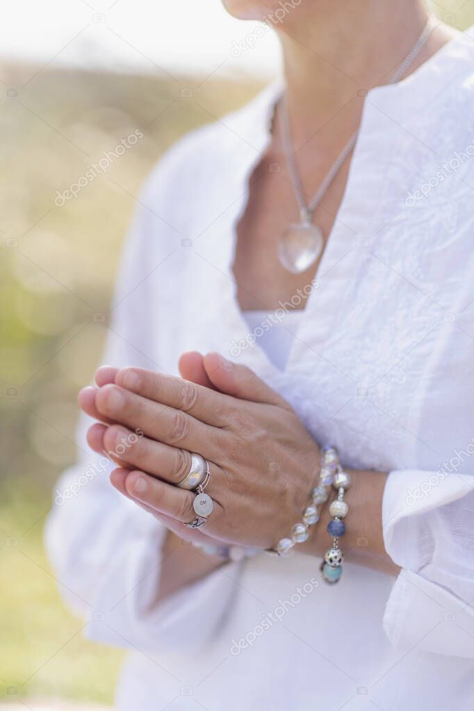 Female spiritual healer practicing mindfulness, sensing and increasing positive energy. Hand gesture