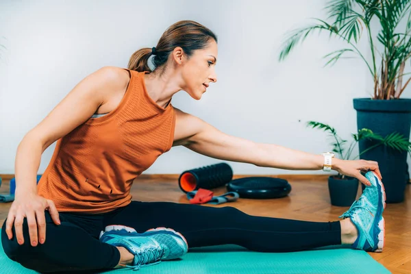 Home Exercising. Woman Stretching at Home