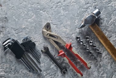 Gri beton zemin üzerine bir çalışma aracı. Somun anahtarları, çekiç, anahtarları hex. Üstten görünüm, kopya alanı