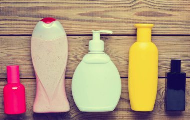 Şişe ve şişe parfüm ahşap bir masa üzerinde duş için ürünler. Kişisel bakım. Hijyen ve güzellik için nesneler. Üstten Görünüm. Düz yatıyordu.