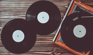 Gramofon ve vinil diskleri bir ahşap zemin üzerinde. Retro medya.