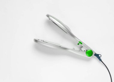 Beyaz bir arka plan üzerinde gümüş rengi için bir saç demir. Saç Bakımı.