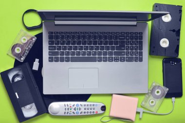 Modern dijital araçlar, depolama kitle iletişim araçları, devaysy ve eski analog ortam aygıtları bir yeşil kağıt arka plan üzerinde. Üstten Görünüm. Düz yatıyordu.