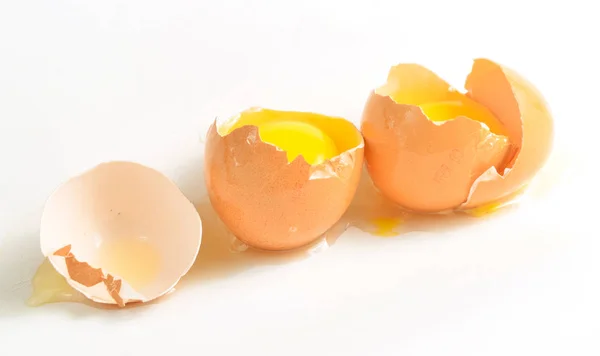 Broken chicken eggs isolated on white background.