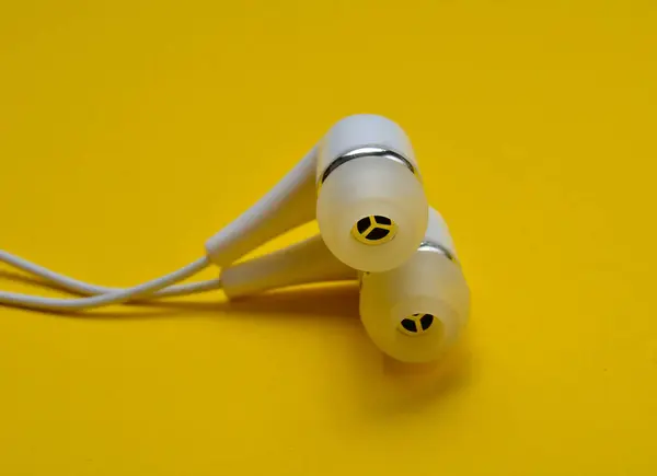 White Vacuum Headphones Close Yellow Background — Stock Photo, Image