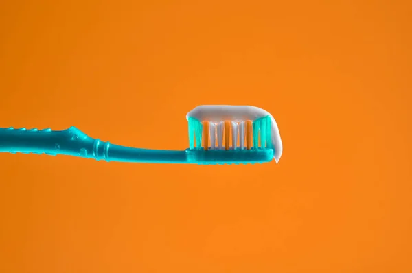 Toothpaste Blue Toothbrush Close Orange Light Background — Stock Photo, Image