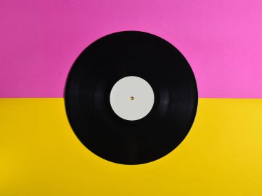 Vinil plaka üzerinde pastel renkli arka plan, retro müzik teknolojisi, üstten görünüm, minimalis