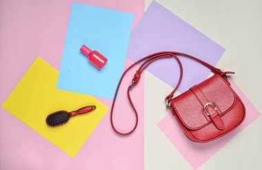 Deri çanta, tarak, pastel renkli bir arka plan üzerinde parfüm şişesi. Minimalizm. Top Vie