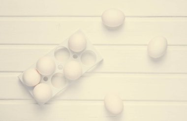 Beyaz ahşap bir masa minimalizm eğilim, üzerinde beyaz yumurta ile plastik tepsi top vie