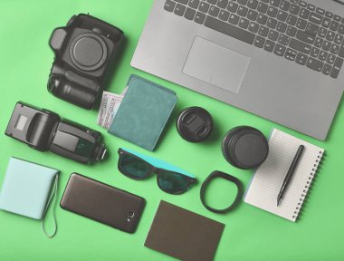 Ekipman fotoğrafçı, laptop, dolar, smartphone, akıllı izle, pasaport, sarı arka plan üzerinde güç banka ile çanta. Serbest kavramı, iş ve seyahat, nesneleri, üst görünümden, düz la için gadgets