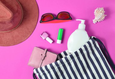 Plaj çantası ve aksesuarları pastel pembe plaj düzenine rahatlamak için. Deniz, yaz saati Resort'ta kavramı. Üstten görünüm, düz yatıyordu, minimalis