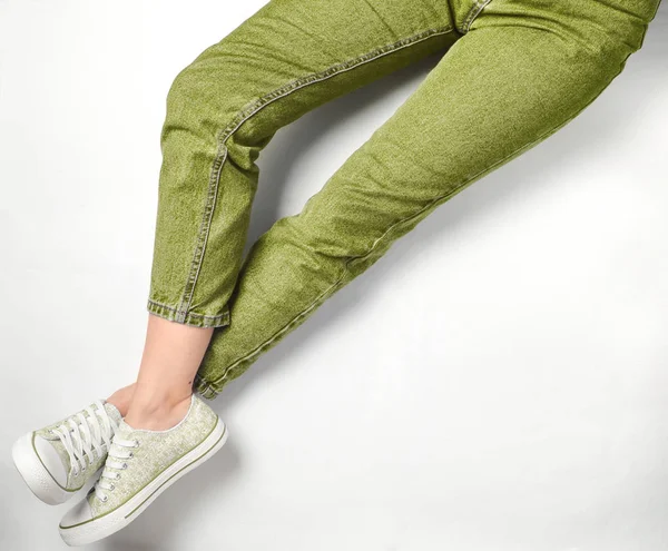 Female Legs Jeans Sneakers White Background Top Vie — Stock Photo, Image