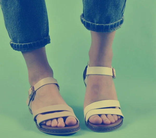 Female Legs Dressed Jeans Shod Sandals Posing Isolated Blue Background — Stock Photo, Image