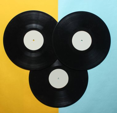 Pastel renkli bir arka plan üzerinde üç retro vinil kayıtlar. Top Vie