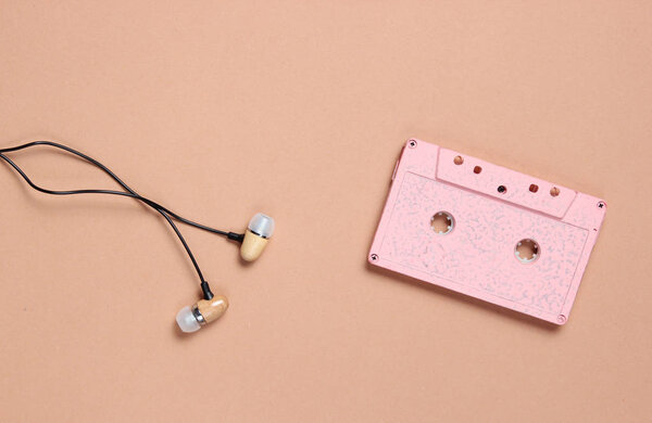 Audio cassette, headphones on a brown background, music lover, minimalism, top vie