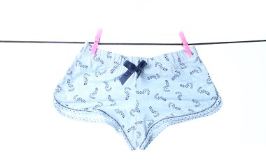 Wonan's panties hanging on  clothesline with buckles isolated on white background. Washed things, washed underwear