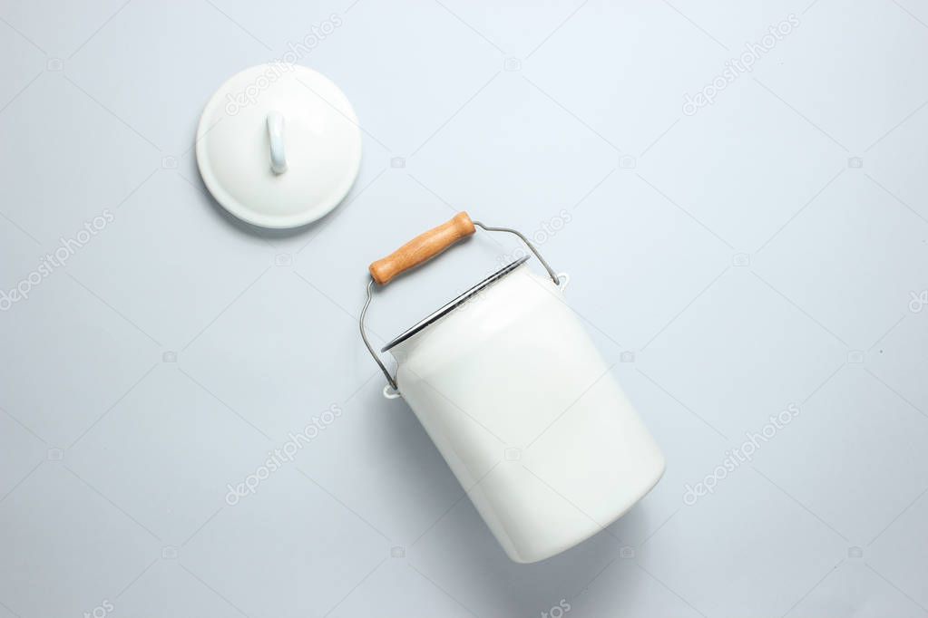 White enameled milk can on a gray background. Top view