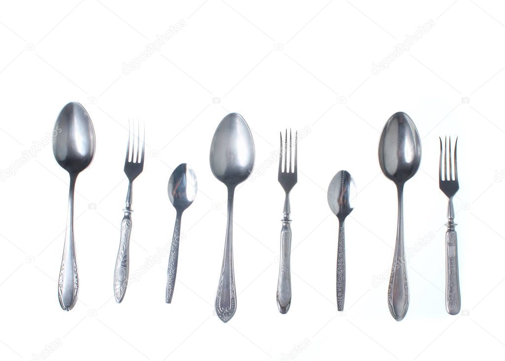 Set of old retro forks and spoons isolated on white background. Top view