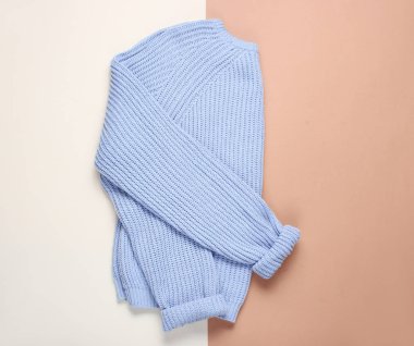 Kahverengimsi bej kağıt arka plan üzerinde Kadın mavi kazak. Üst görünüm, minimalizm