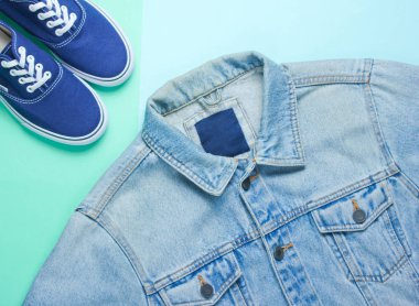 Retro tarzı Denim şık ceket ve hipster Sneakers nane renkli kağıt arka planda. Minimalizm, üst görünüm, düz yatıyordu