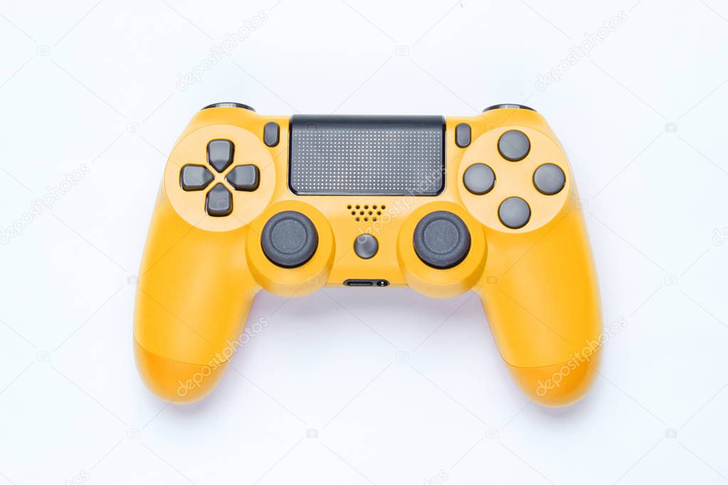 Modern yellow gamepad (joystick) on gray background. Top vie