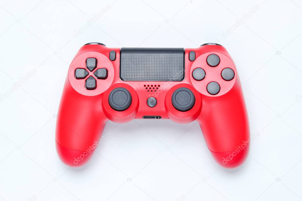 Modern red gamepad (joystick) on gray background. Top vie