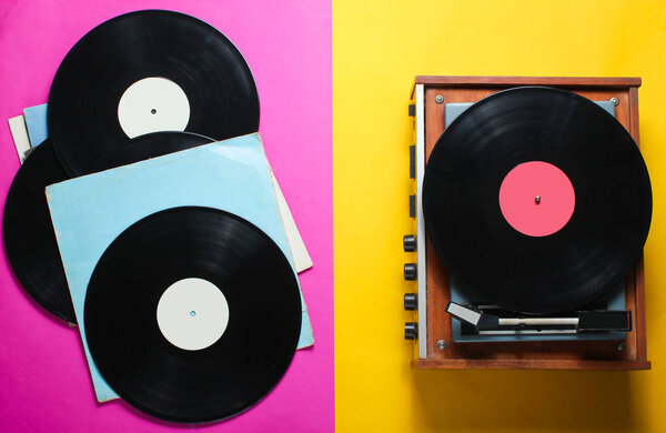 Retro style viny player and vinyl records with covers on a colored paper background. Pop culture, Top vie